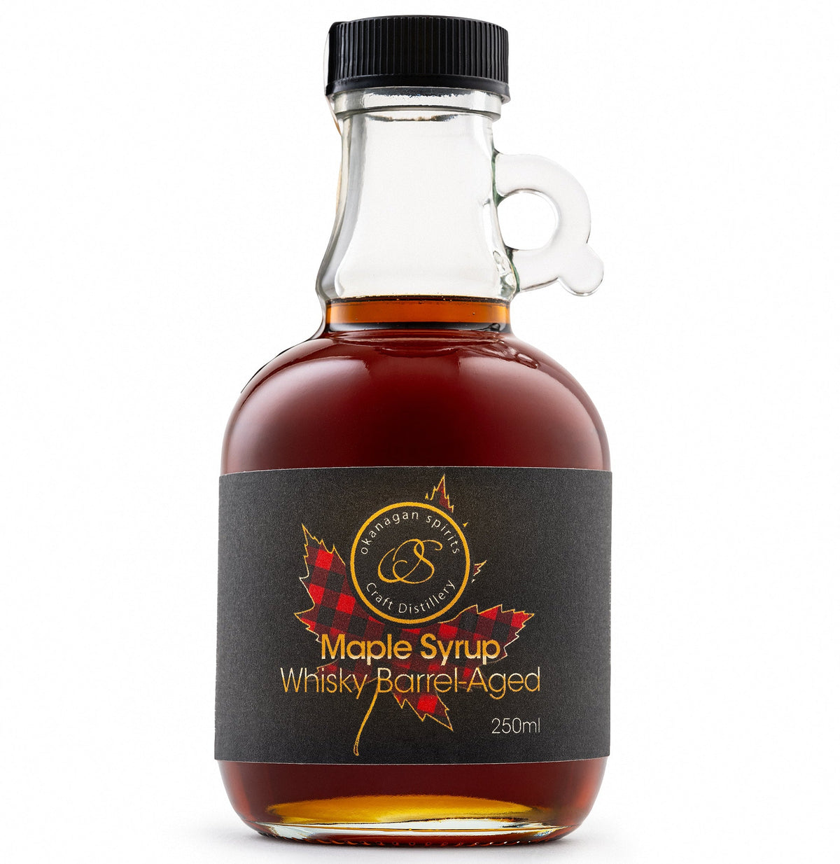 A 250ml bottle of Barrel Aged maple syrup by Okanagan Spirits, featuring amber liquid in a clear glass bottle with a black cap and a black label with red maple leaf graphics.